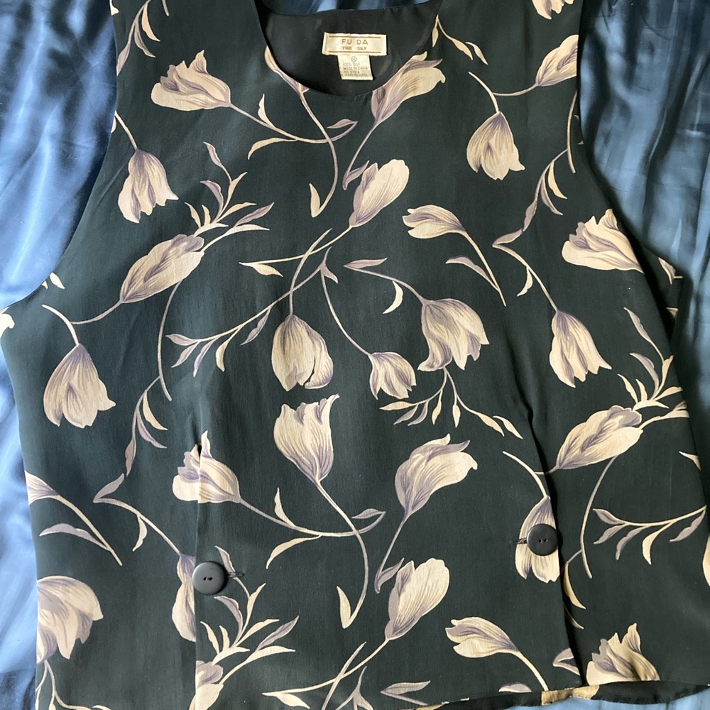 100% silk tank top with buttons on front and belt in back to adjust
